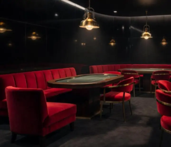 Velvet-lit offline poker lounge with custom poker tables and brass lighting